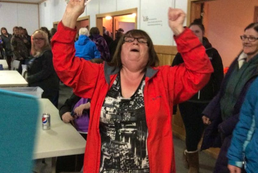 Alice Flynn of Conche is overjoyed as she holds up the Ace of Spades, winning over $25,000 in Conche’s Chase the Ace fundraiser.