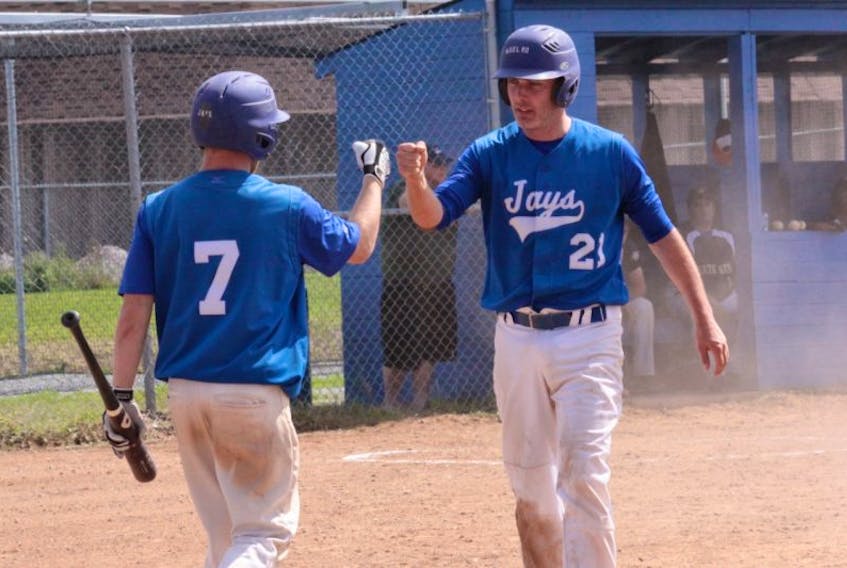 <p>Kyle McCulloch, left, and Darrell McClellan&nbsp;celebrate the Noel Road Blue Jays' win over the Yarmouth Gateways in the first game of a double elimination final. The Jays went on to win the second game, and earn the 2014 Nova Scotia Intermediate Baseball League title.</p>
