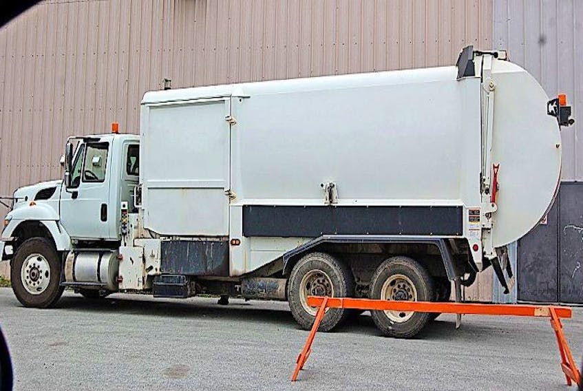 A garbage disposal truck during collection of refuse from Springdale Stadium.