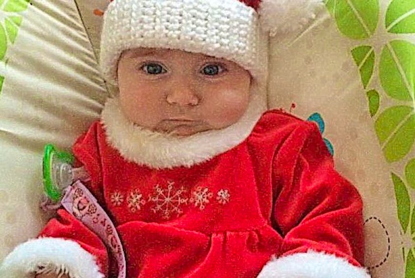 Seasons Greetings from 3 ½ -month-old baby Quinn, daughter of Clint Newbury and Andrea Head of King’s Point, wearing her cousin Marissa’s dress and a hat crocheted by Rosalind Walsh of Baie Verte. The hats are made and sold each Christmas to help Parkinson's NL.