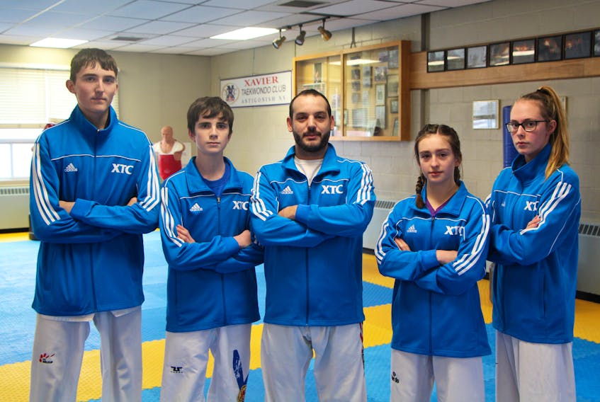 Athletes Ewan MacDuff (left), Cole Allen, Leah Grant and Rebekah Pitts, from Antigonish-based Xavier Taekwondo, are ready to compete in a national competition Jan. 10 to 12 in Quebec City. Instructor Jeremy Reeve, in centre of photo, noted how the four prepared by attending a competition in Michigan at the start of December.