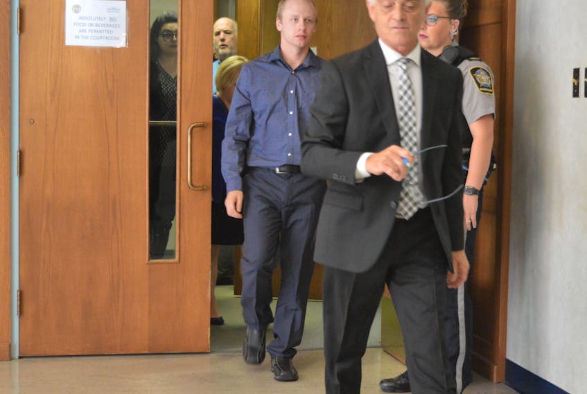 Hayden Kenneth Laffin of Bras d’Or, left, is shown following a brief provincial court appearance in Sydney in September 2018. At the front is Laffin's lawyer David Iannetti. CAPE BRETON POST 