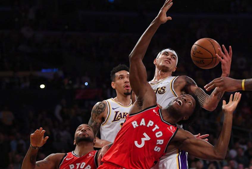 Raptors’ OG Anunoby and  Lakers’ Kyle Kuzma go for a rebound as Raps’ Norman Powell and Lakers’ Danny Green close in during Sunday’s game. Anunoby departed Monday’s game against the Clippers early with an eye injury. (GETTY IMAGES)