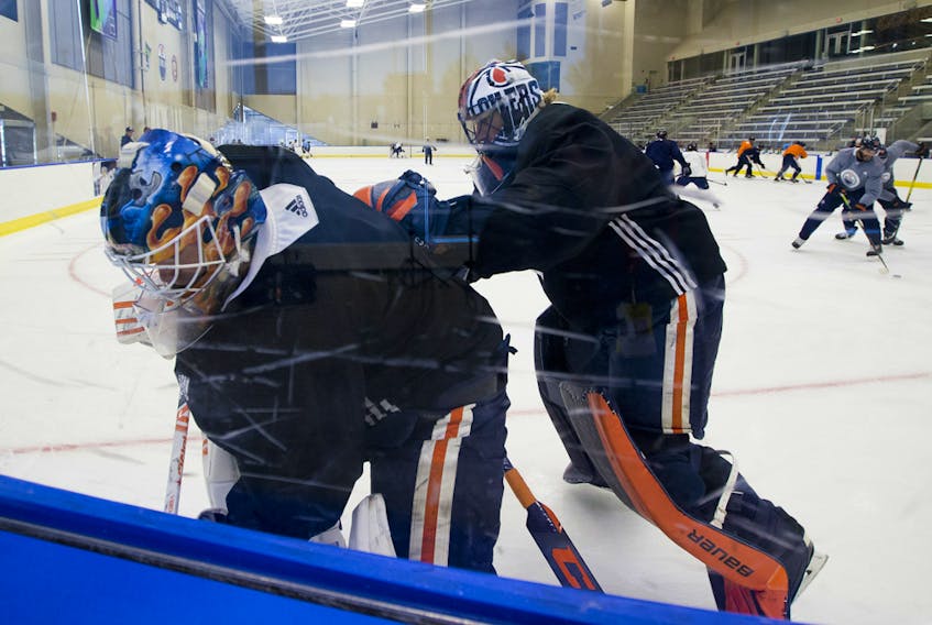 Goaltenders Mikko Koskinen (left) and Mike Smith take part in the Edmonton Oilers return-to-play camp at the Downtown Community Arena on Tuesday, July 14, 2020.