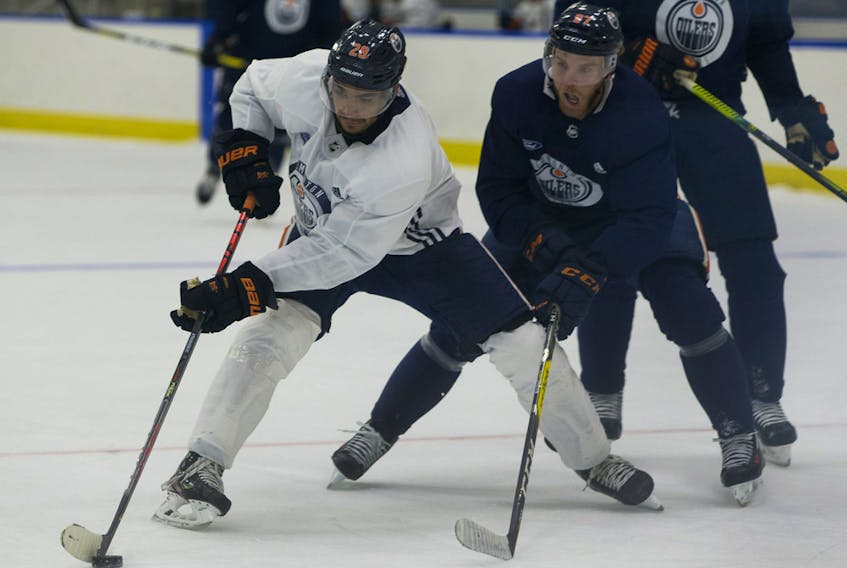 Connor McDAvid chases after Andreas Athanasiou during dDay 2 of the Edmonton Oilers return-to-play camp at the Downtown Community Arena on Tuesday, July 14, 2020.