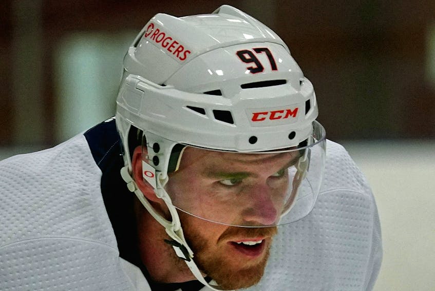 There is an increased amount of advertising around the Edmonton Oilers brand, as can be seen on the helmet of team captain Connor McDavid in training camp ahead of the 2021 NHL season, which opens Wednesday, Jan. 13, 2021.