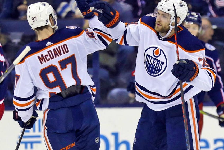 Edmonton Oilers forward Leon Draisaitl, right, of Germany, celebrates his goal against the Columbus Blue Jackets with teammate forward Connor McDavid during the second period of an NHL hockey game in Columbus, Ohio, Saturday, March 2, 2019.