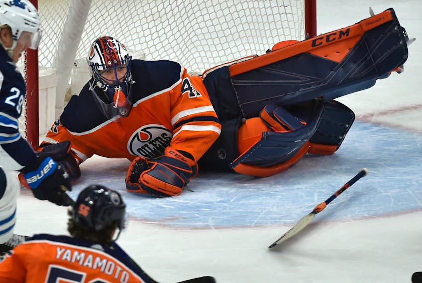 Edmonton Oilers goalie Mike Smith (41) dives across the cease and loses his stick after being caught out of position against the Winnipeg Jets at Rogers Place on March 11, 2020.