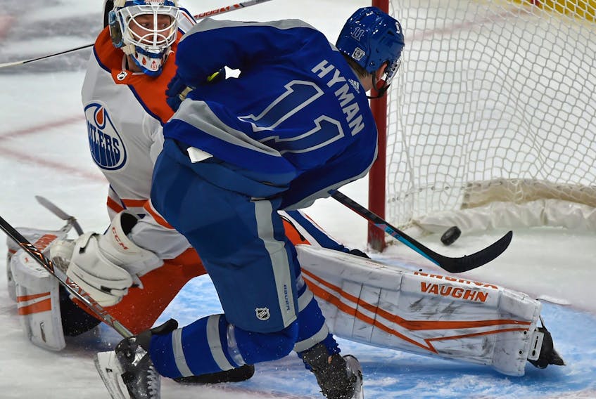 Toronto Maple Leafs Zach Hyman (11) scores on Edmonton Oilers goalie Mikko Koskinen (19) during NHL action at Rogers Place in Edmonton on Saturday night. 
