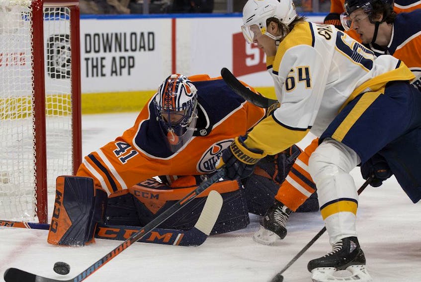 The Edmonton Oilers' goalie Mike Smith (41) and Kailer Yamamoto (56) battles the Nashville Predators' Mikael Granlund (64) during second period NHL action at Rogers Place, in Edmonton Saturday Feb. 8, 2020. 