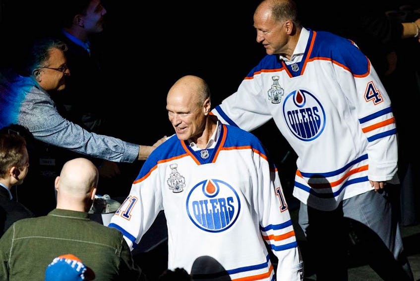 Mark Messier, left, and Kevin Lowe greet fans during the NHL's Greatest Team celebration recognizing the 1984-85 Edmonton Oilers team at Rogers Place in Edmonton on Sunday, Feb. 11, 2018. 