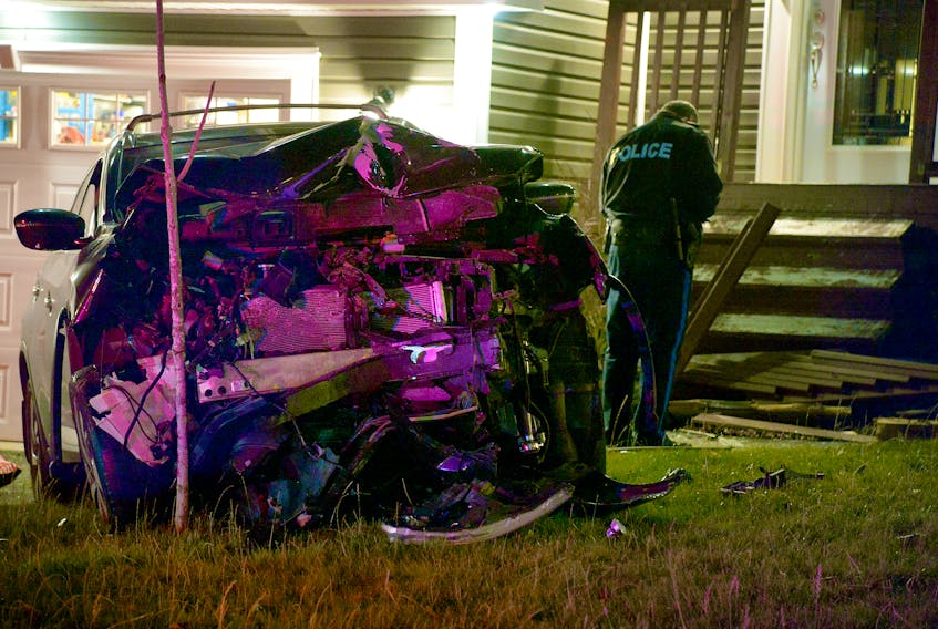 One man was in custody after a two-vehicle crash that also damaged a home in Paradise early Saturday morning. Keith Gosse/The Telegram