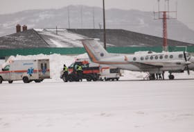 A patient is loaded onto an air ambulance flight from one of two road ambulances on the tarmac at Stephenville airport the morning of Jan. 29. FRANK GALE/ THE WESTERN STAR