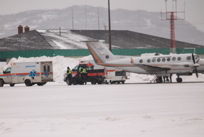 A patient is loaded onto an air ambulance flight from one of two road ambulances on the tarmac at Stephenville airport the morning of Jan. 29. FRANK GALE/ THE WESTERN STAR