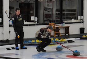 Greg Smith (left) looks on as opposing skip Colin Thomas calls the line on a shot during the 2021 Newfoundland and Labrador Tankard men’s curling final at the Re/Max Centre in St. John’s on Sunday afternoon. Smith defeated Thomas 9-8 in 12 ends to advance to the Tim Horton’s Brier in Calgary March 6-14. — Joe Gibbons/The Telegram
