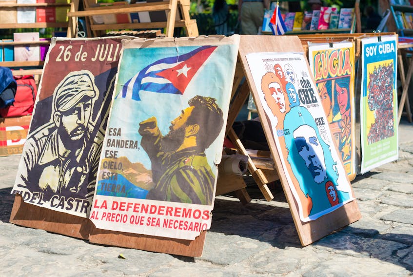 Posters with revolutionary slogans are for sale at a street market in Cuba. The CIA was once involved in introducing an African swine virus into the neighbouring country. 