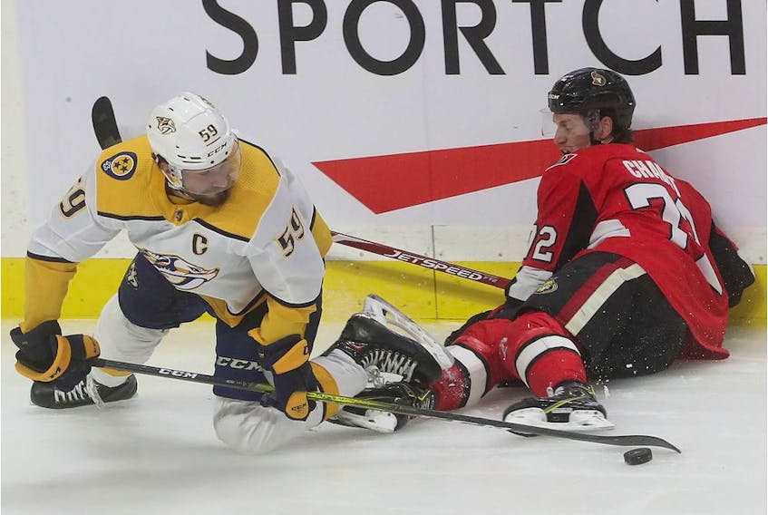 Ottawa Senators Thomas Chabot tries to get the puck from Roman Josi during second period action against the Nashville Predators at Canadian Tire Centre in Ottawa, Dec 19, 2019. 