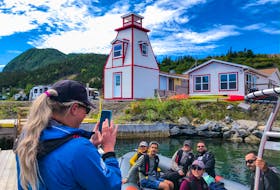 Wild Gros Morne Outdoor Experiences owner Becky O’Keefe, taking a picture of a group on one of the company’s zodiac tours, is seeing positives in operating during the COVID-19 pandemic.