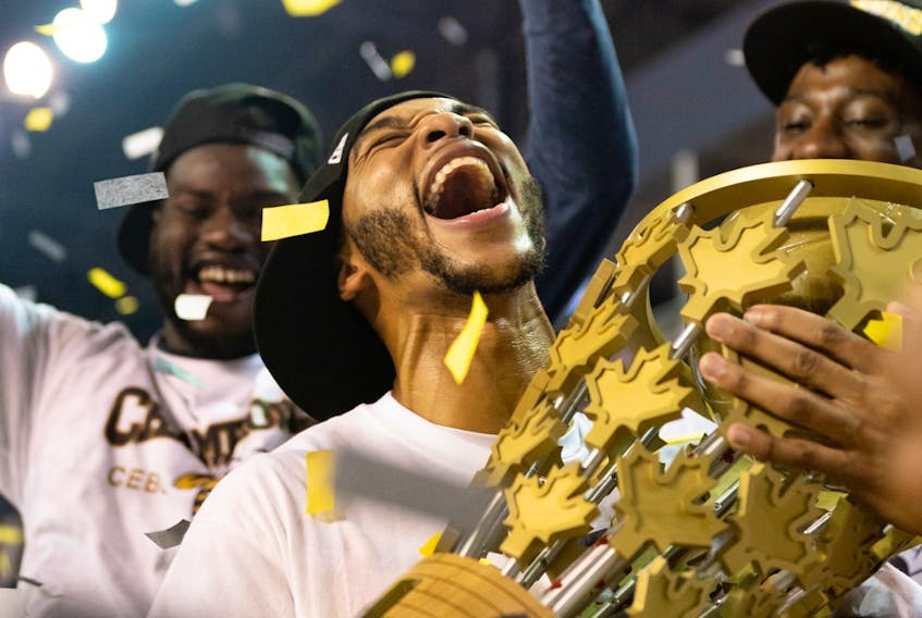 Edmonton Stingers guard Xavier Moon hugs the Canadian Elite Basketball League championship trophy after leading his team to a 90-73 win over the Fraser Valley Bandits in the Summer Series final at Meridian Centre in St. Catharines, Ont., on Aug. 9, 2020.