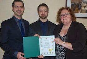 Adam Rowe and Chad Collett of SubC Imaging receiving their Business of the Year award from Barbara Crann.