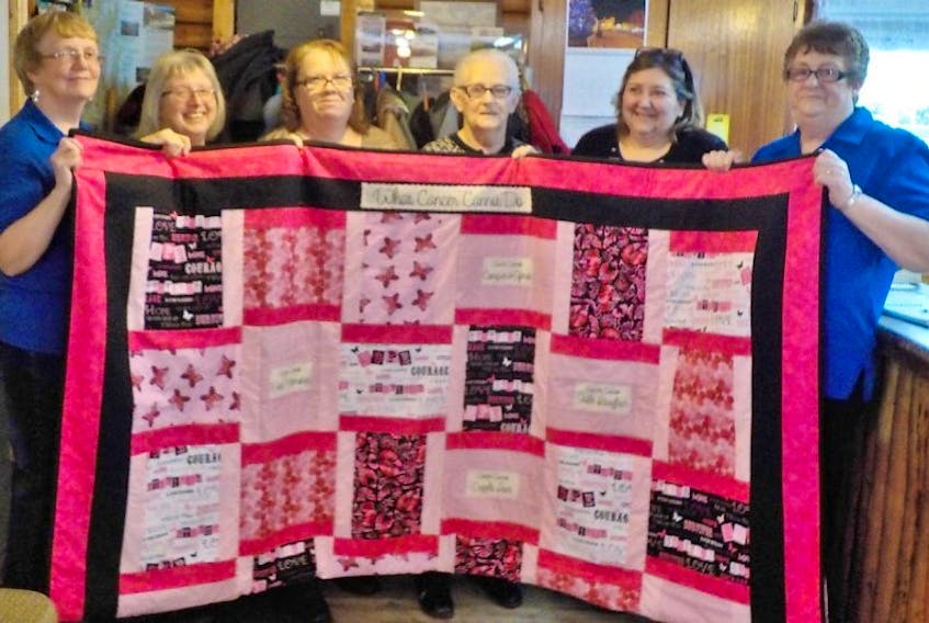 From left to right, Deanne Hiscock, Joyce Poole, Bonnie Mackey, Clara Duffett, Edith Samson and Genevera Burry gather for special presentation of the Pink Ribbon-Cancer quilt to a local cancer support group for a ticket fundraiser.