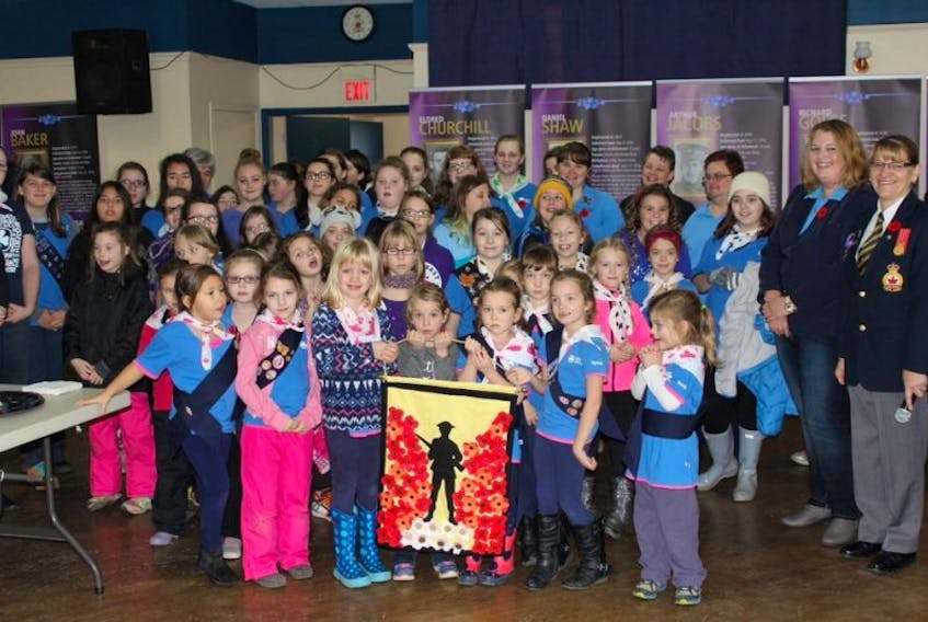 The girls and Guiders presented their Poppy banner to the Clarenville Legion.
