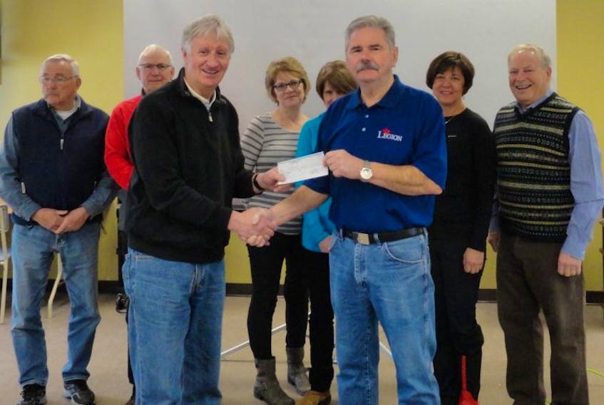 Bill Meadus (right), Treasurer of the Royal Canadian Legion presents cheque to CREST Chairperson, Larry Reid at a recent Random Age-Friendly Board meeting.