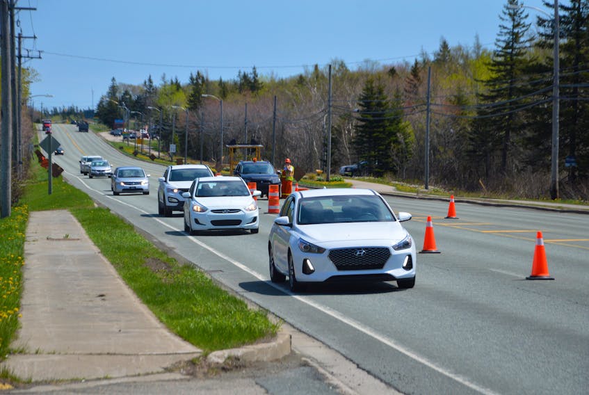 Traffic was down to one lane in both directions on Grand Lake Road near the Myles F. Burke police headquarters in Sydney Thursday morning as workers painted lines and turning signals on the road. Line and turning signals are being painted across the Cape Breton Regional Municipality and motorists are advised to slow down and use caution when work is taking place. JEREMY FRASER/CAPE BRETON POST  