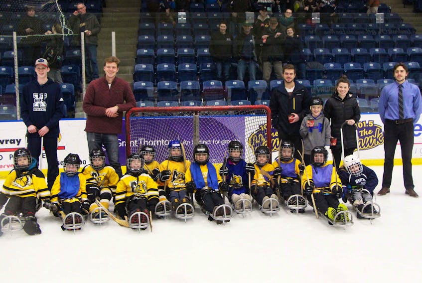 Participants in the inaugural X-Sledge Hockey Tournament, organized by St. F.X. human kinetics students, gather for a photo during the March 14 afternoon event, held at the Keating Centre.