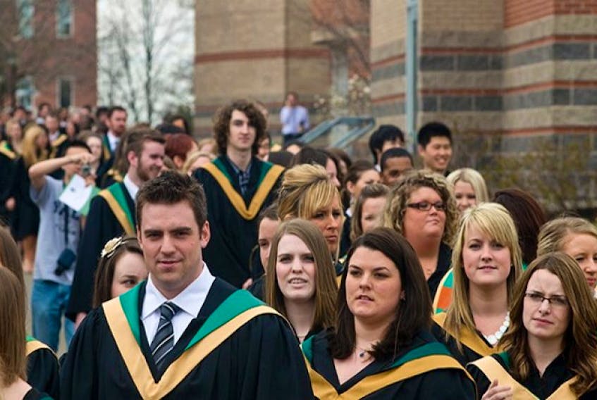 Graduates parade into the Chi-Wan Young sports centre on the UPEI campus for the annual Mother's-Day-weekend graduation ceremony. It was the largest UPEI class in history, just four graduates short of 900.