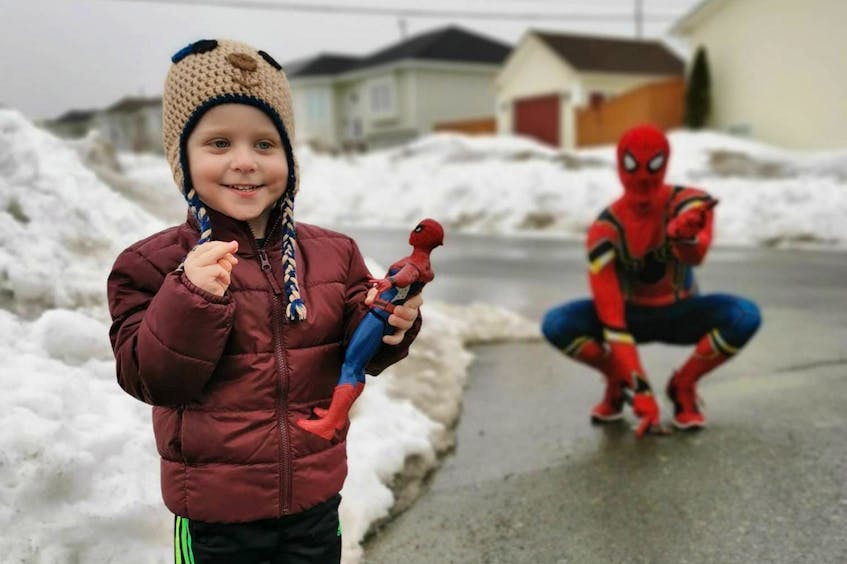 Three-year-old Lincoln Pendergast — son of Lincoln Pendergast and Lisa Fitzgerald — of Paradise was over the moon to see his favourite superhero visit his street Tuesday. Robbie Griffiths, who also lives in Paradise, is dressing up as Spider-Man and walking the neighbourhood to entertain kids and their parents in an effort to take their minds off the COVID-19 pandemic. — PHOTO BY LISA FITZGERALD