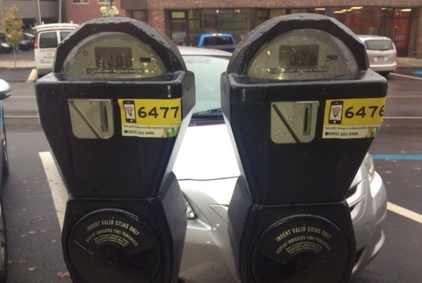 ["All of Charlottetown's parking meters are now smartcard compatible. Each has been outfitted with these numbered yellow stickers."]