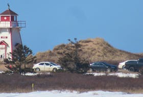 This picture taken Sunday at the Covehead Lighthouse, adjacent to Covehead Harbour in the P.E.I. National Park, shows cars parked on the Gulfshore Parkway East. A no-parking regulation, which was announced on Friday, prohibits parking in the P.E.I. National Park, including along highways and roads, as well as in parking lots.