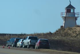 This picture taken Sunday at the Covehead Lighthouse, adjacent to Covehead Harbour in the P.E.I. National Park, shows cars parked on the Gulfshore Parkway East. A no-parking regulation, which was announced on Friday, prohibits parking in the P.E.I. National Park, including along highways and roads, as well as in parking lots.