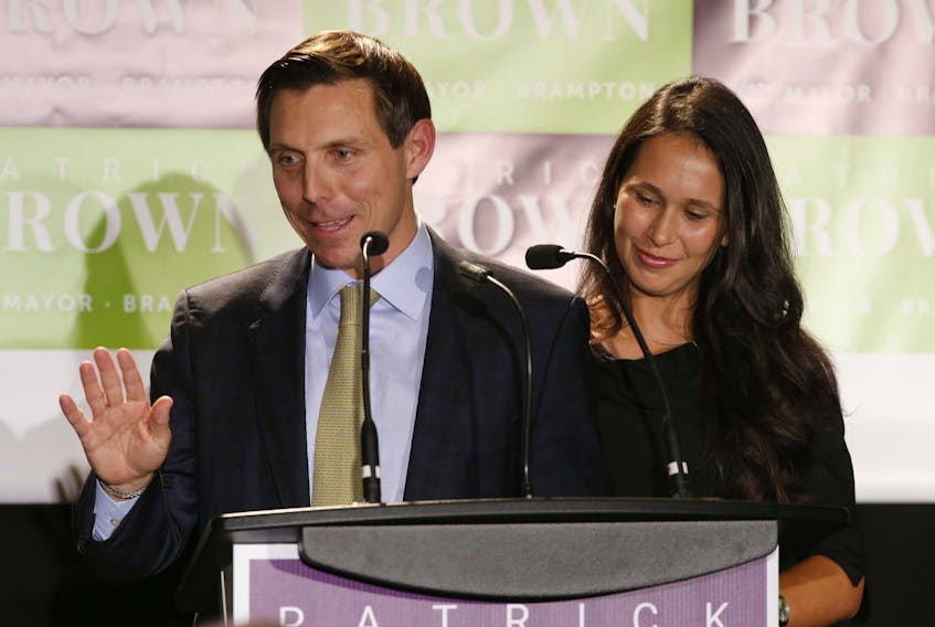 Patrick Brown, flanked with his wife Genevieve, is ushered in as the new mayor of Brampton, Monday October 22, 2018. 