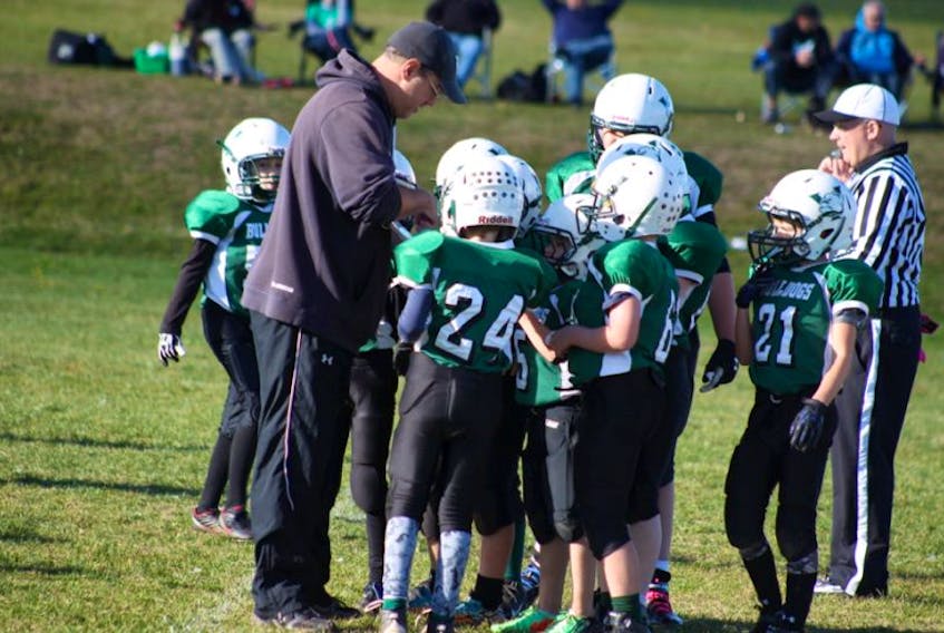 Head coach Paul Arsenault gives some words of advice to his atom Bulldogs players earlier this season. Arsenault was announced last week as one of 10 Canadian finalists for the NFL Youth Coach of the Year award.&nbsp;