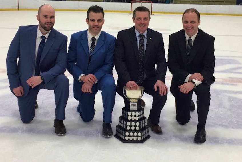 St. Francis Xavier men’s hockey coach Brad Peddle (second from the right) and assistants Brian Casey (right), Sean Donovan (left) and Dave Stewart pose with the Atlantic University Sport men’s hockey championship trophy after the X-Men defeated the University of New Brunswick for the conference title in Antigonish, N.S., last week. Peddle is from Goulds and Casey is from Grand Falls-Windsor. St. FX will compete for the U Sports Canadian men’s championship beginning today in Fredericton, N.B.