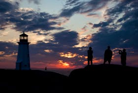 Visitors to Peggys Cove enjoy a dramatic sunset in 2017. - File