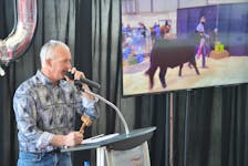 Auctioneer Brian Craswell takes bids for the grand champion at the P.E.I. Easter Beef Show and Sale in Charlottetown on Friday.