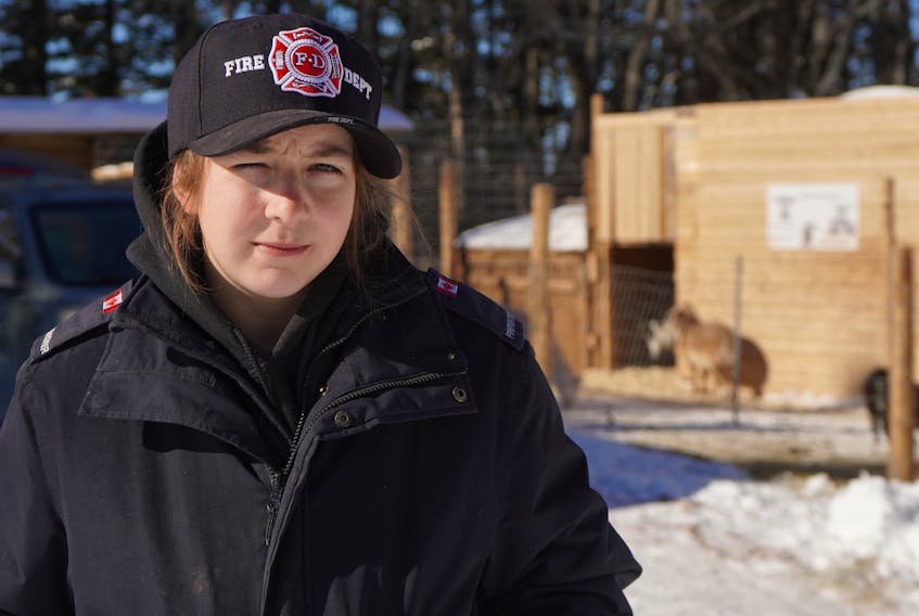 Emily Oliver stands outside at her rescue farm near Oyster Bed Bridge on Thursday.