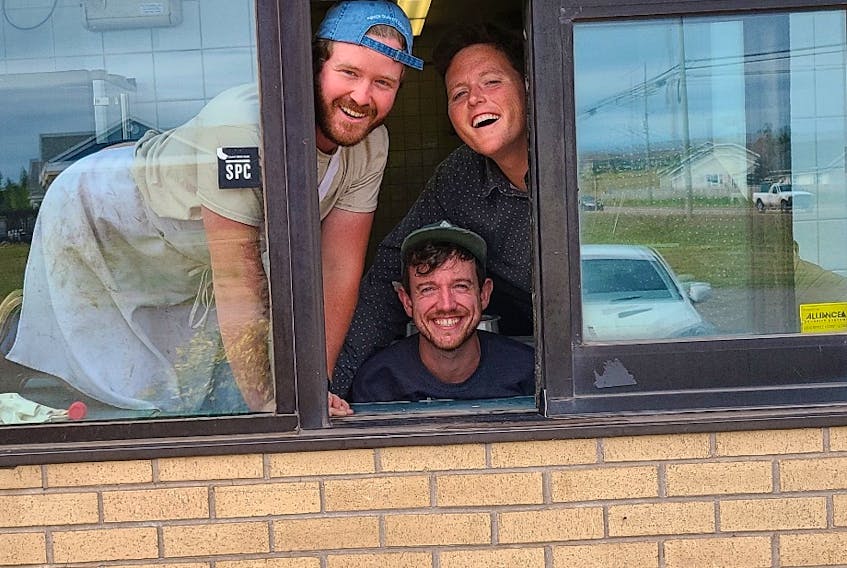 Nimrods' co-owners Jesse Clausheide, left, and Mikey Wasnidge, right, pose with general manager Bruce Rooney in the drive-thru window of their temporary Burger Love location in the former KFC location in Stratford.