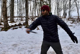 Dennis MacKenzie, founder of Brave and Broken, demonstrates how to properly throw a disc to play disc golf at Huck It Disc Golf in Kinkora on Feb. 7