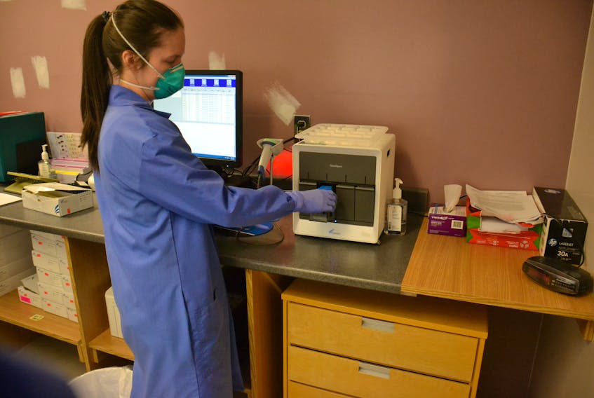 Kari-Lyn Rutley, a medical laboratory technologist, works with a Cepheid GeneXpert device, used to process COVID-19 tests. P.E.I.'s diagnostic labs successfully ramped up testing during the recent outbreak this past week.