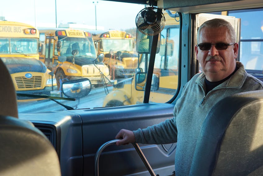 Mike Franklin, transportation supervisor with the Public School Branch, stands in a bus in Charlottetown on Feb. 19.