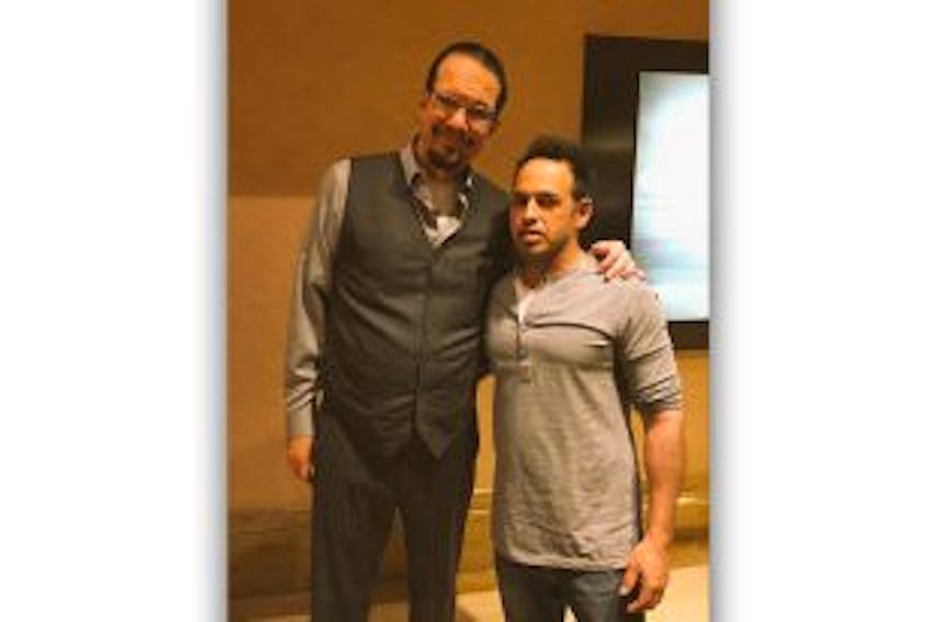 ['American magician and comedian Penn Jillette poses for a photo with Newfoundland actor and comedian Shaun Majumder.']