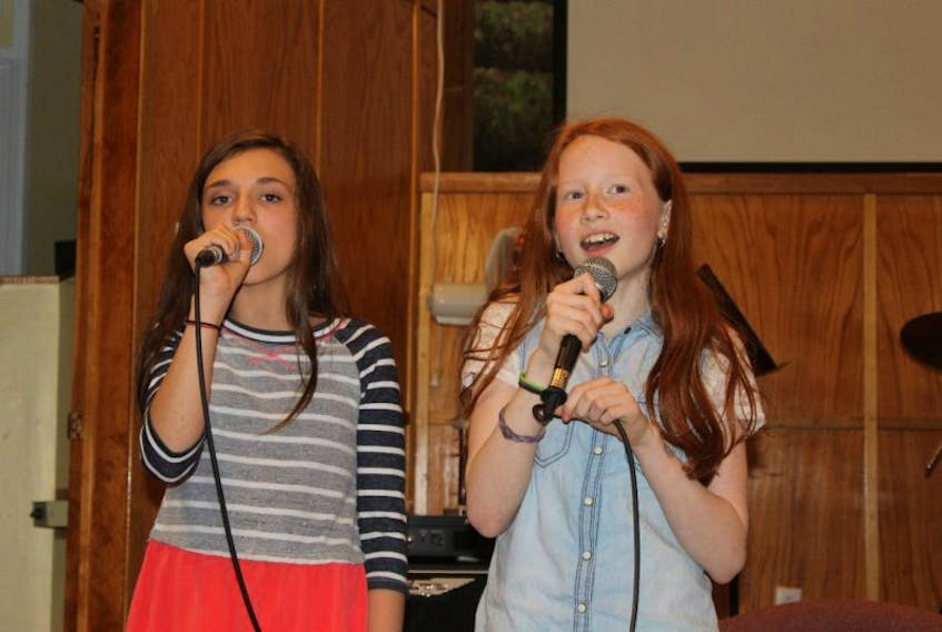 Olivia Sheppard and Lyndsey Fleming were two of the performers for the Pentecostal singspiration held on May 22. 