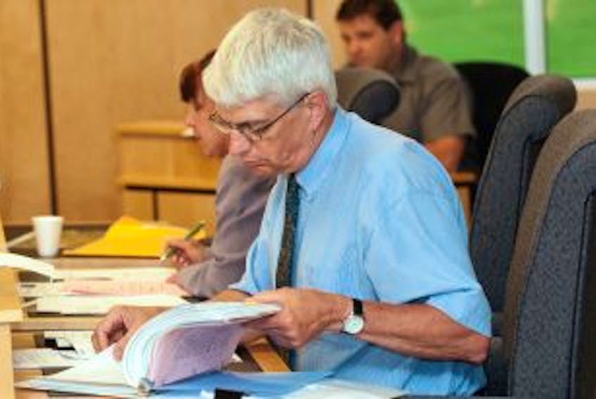 ['Cornwall town councillor Peter Meggs checks some paperwork during the regular meeting of council Wednesday night. ']