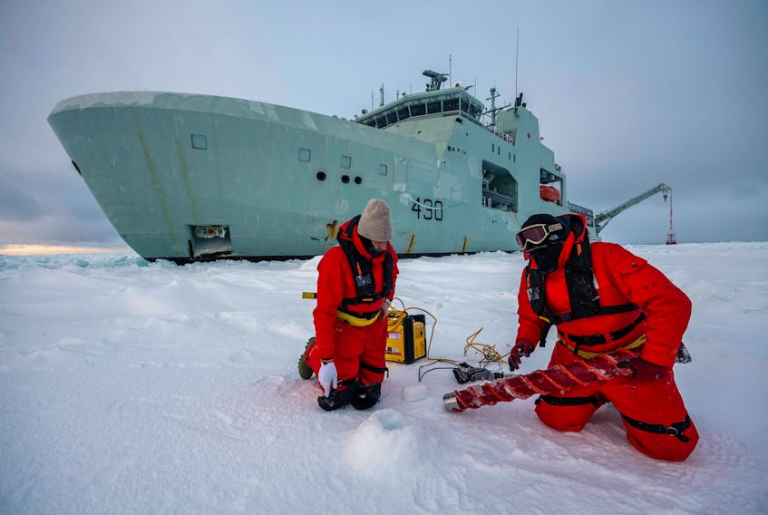 Civilian contractors conduct ice measurement operations alongside HMCS Harry DeWolf during cold weather trials near Frobisher Bay on Feb. 20, 2021. Cpl. David Veldman -  Canadian Armed Forces 
 
