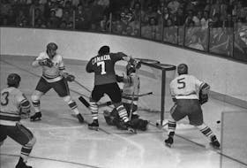 Canada's Phil Esposito (7) is surrounded by opponents as he tries to jam the puck past Soviet goaltender Vladislav Tretiak during Game 4 of the 1972 Summit Series in Vancouver. The trainer for the Soviet team during their four games in this country was Canadian Rick Noonan. — Postmedia file photo/Ken Oakes/Vancouver Sun
