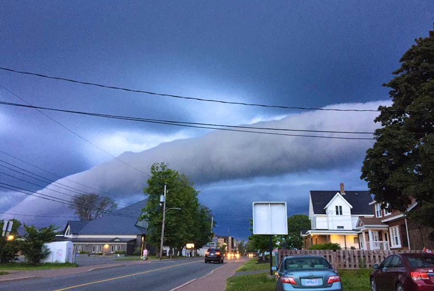 A roll cloud is a relatively rare, low-level horizontal, tube-shaped “accessory cloud” completely detached from the cumulonimbus cloud or thunderstorm base.  Here's a photo of one over Amherst July 10 by Charlie Rhindress.